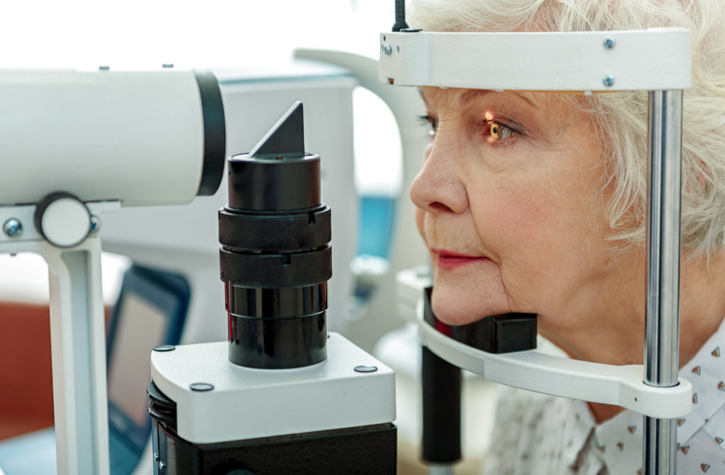 Senior woman sitting in front of machine during tonometry test for glaucoma