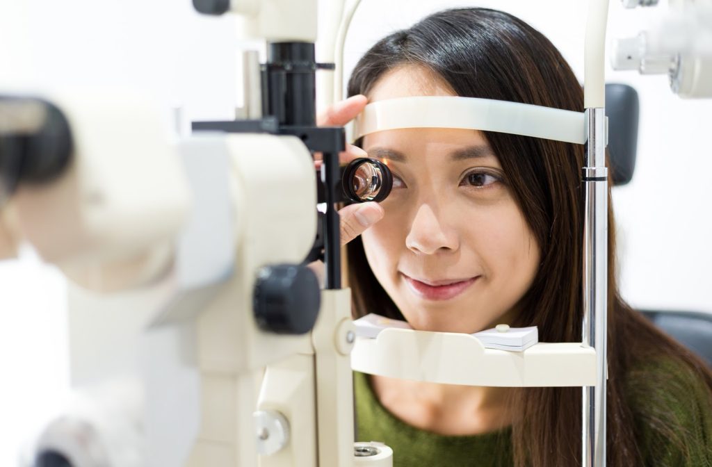 Young woman undergoing eye exam by her optometrist.
